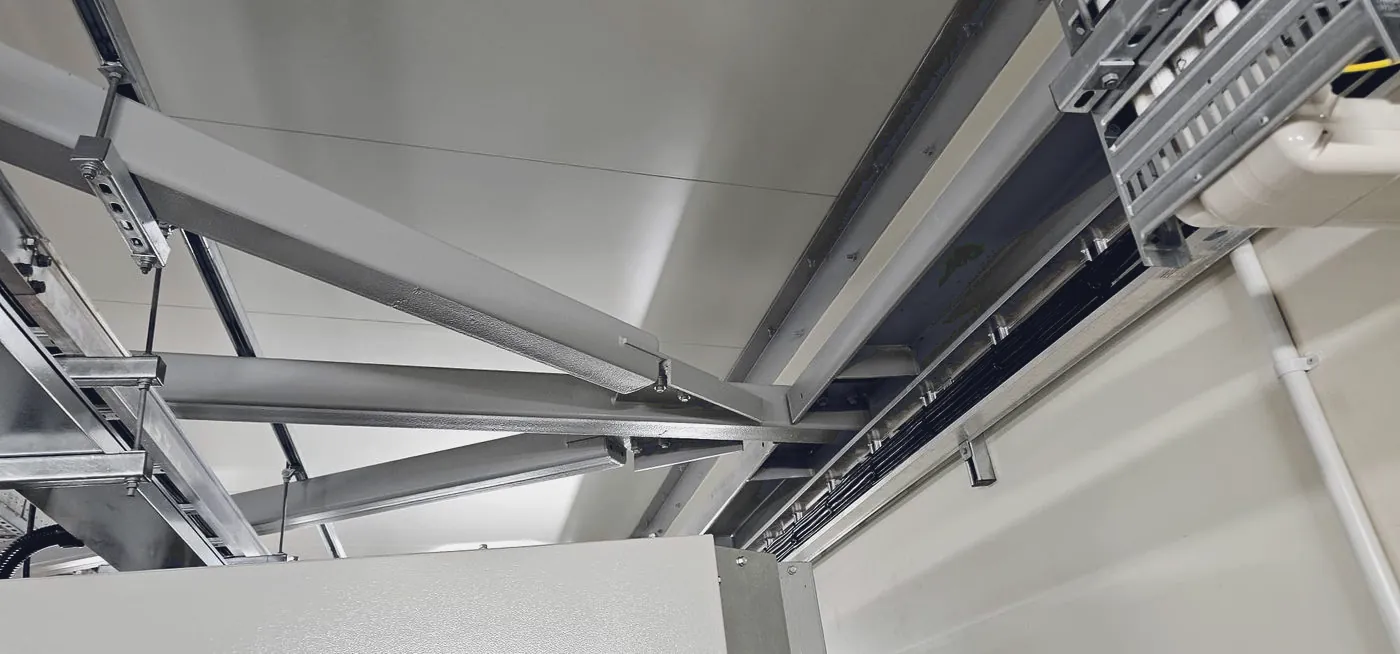 Coated structural beam and bracing with services running alongside
