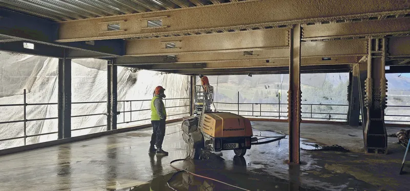 Spray pump and operator set up on a concrete deck